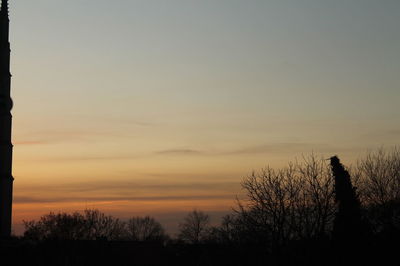 Silhouette trees against sky during sunset