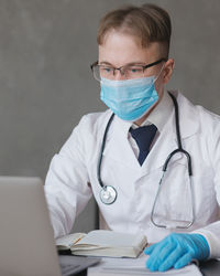 Portrait of doctor using laptop