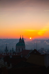 Buildings against sky during sunset