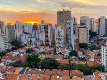 High angle view of buildings in city against sky during sunset