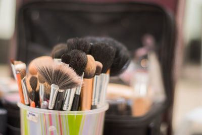 Close-up of make-up brushes in container