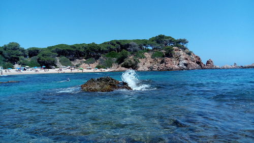 Scenic view of sea against clear blue sky