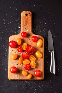 Directly above shot of fruits on table against black background