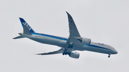 Low angle view of airplane against clear sky