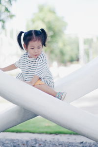 Cute girl sitting outdoors