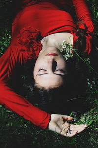 High angle view of woman lying on grass