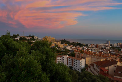 High angle view of townscape by sea against sky