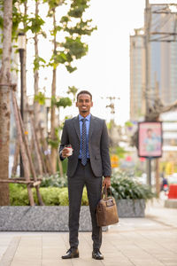 Full length of young man standing in city