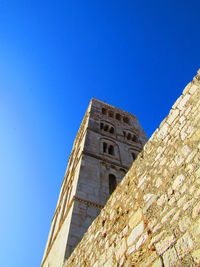 Low angle view of old building against blue sky