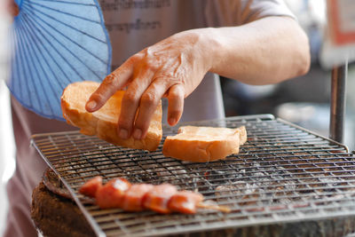 Man preparing food on barbecue grill