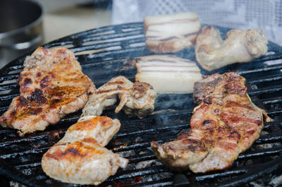 High angle view of meat on barbecue grill