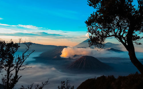 Smoke emitting from volcanic mountain against sky