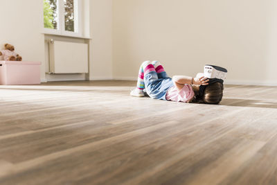 Girl in empty apartment wearing vr glasses