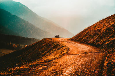 Road amidst land against sky