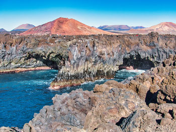 Scenic view of rocks in mountains against sky