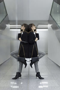 Rear view of women standing on tiled floor