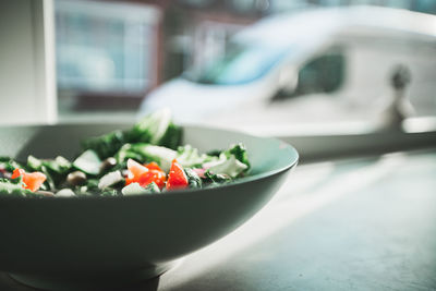 Close-up of chopped fruits in bowl on table