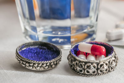 Close-up of multi colored glass on table