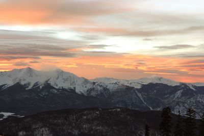 Scenic view of snowcapped mountains during sunset