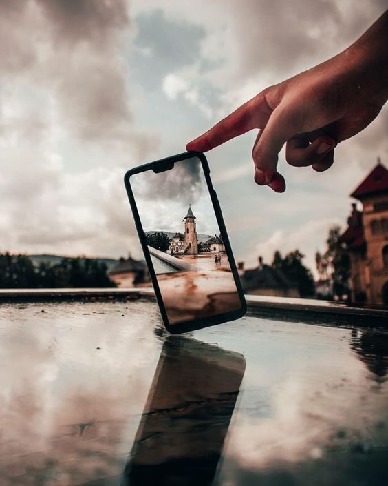 reflection, hand, water, sky, cloud, black, nature, one person, adult, person, outdoors, men, blue, morning, communication, wireless technology, holding, lifestyles, activity, architecture, technology