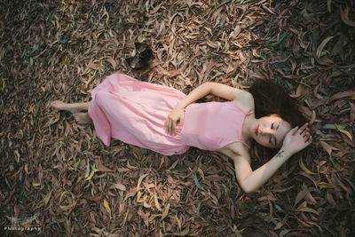 High angle view of young woman sleeping on grass