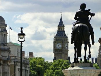Low angle view of building against cloudy sky