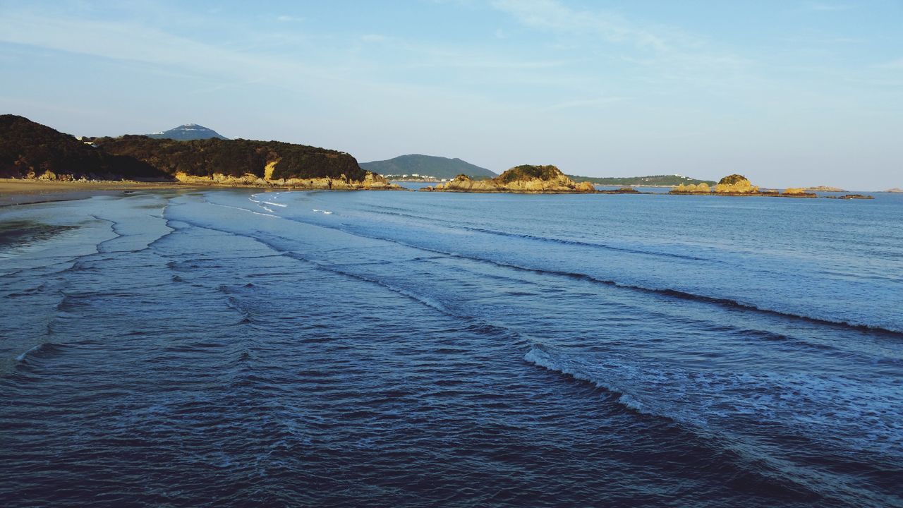 water, tranquil scene, sea, tranquility, sky, scenics, mountain, beauty in nature, nature, beach, blue, idyllic, shore, rippled, waterfront, sand, coastline, remote, cloud, day