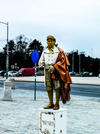 Statue of man against sky