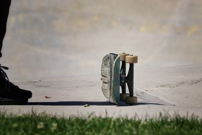 Close-up of skateboard on beach