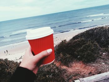 View of hand with coffee cup