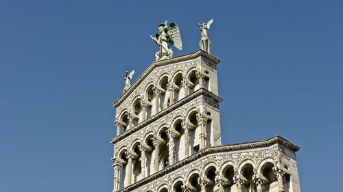 Low angle view of statue against blue sky
