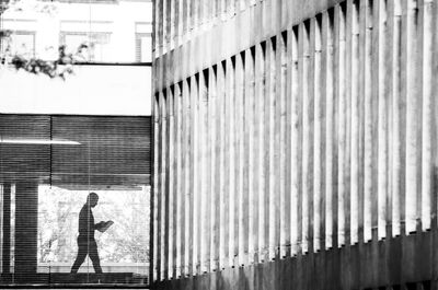 Full length of man standing against building in city