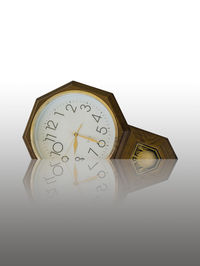 Close-up of clock over white background