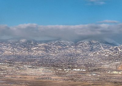 High angle view of snowcapped mountain against sky