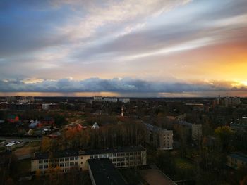 High angle shot of townscape against sky at sunset