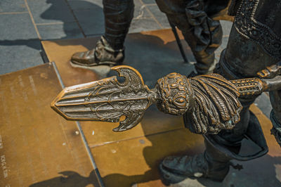 Low section of man holding umbrella