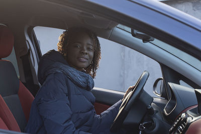 Portrait of woman sitting in car