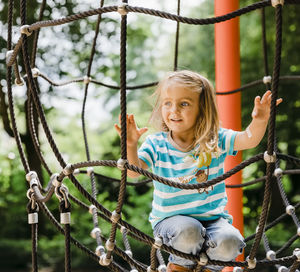 Cute girl on ropes in playground