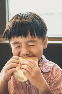 Close-up of boy eating burger
