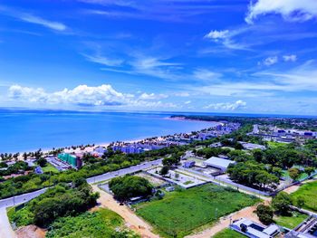 High angle view of buildings and sea against sky