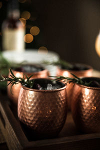 Copper mugs and rosemary sprigs arranged for celebration and entertaining during the holidays 