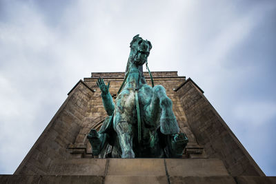 Low angle view of statue in dortmund against sky