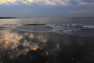 Scenic view of sea against cloudy sky