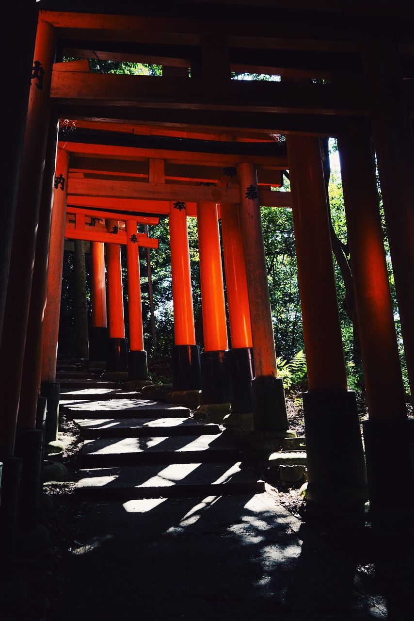 built structure, architecture, religion, place of worship, red, spirituality, architectural column, building exterior, temple - building, orange color, indoors, column, travel destinations, entrance, sunlight, famous place, wood - material, temple, history