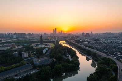 High angle view of buildings against sky during sunset