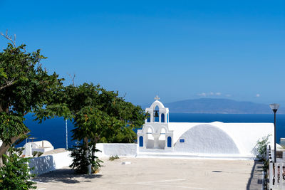 Typical detail of a bell tower of an orthodox white church in the village of oia, santorini, greece.