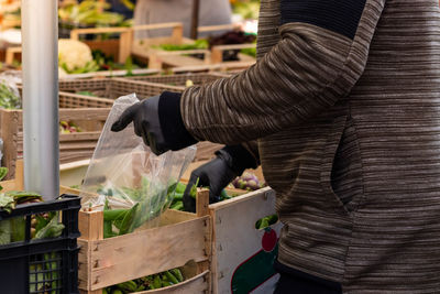 Midsection of man working at market