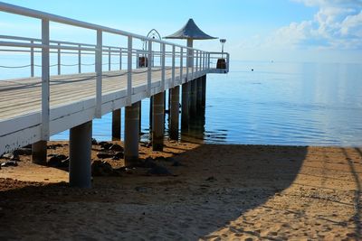 Lifeguard hut on beach against sky