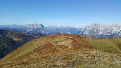 Scenic view of mountains against clear blue sky