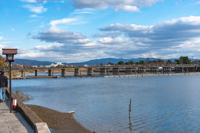 Pier over river against sky